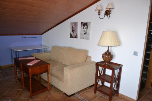 a living room with a couch and two tables at Apartamentos Rurales Natura in Torrejón el Rubio