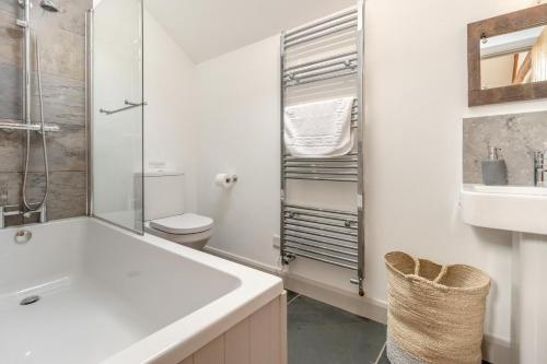 a white bathroom with a sink and a toilet at 3 Bed in Machynlleth oc-bow40 in Darowen