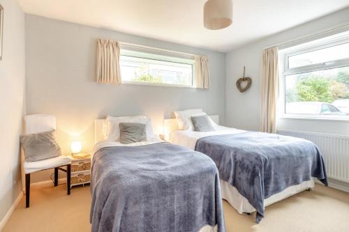 a bedroom with two beds and a window at 2 Bed in Dulverton oc-badger in Dulverton