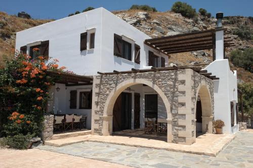 a white house with an archway in front of it at Keramos Villa in Kerames
