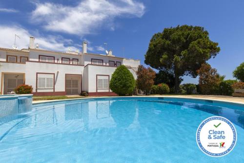 a large swimming pool in front of a building at B75 - Casa Delfim in Alfanzina Carvoeiro in Carvoeiro