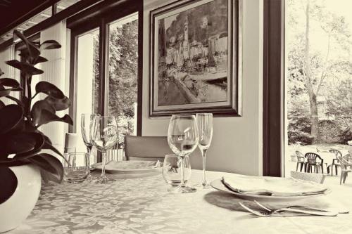 a table with wine glasses and plates on it at Eurohotel Palace Maniago in Maniago