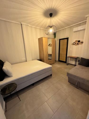 a bedroom with a large bed and a table at SUNRISE SEA VIEW SUITE by Eden in Paralia Katerinis