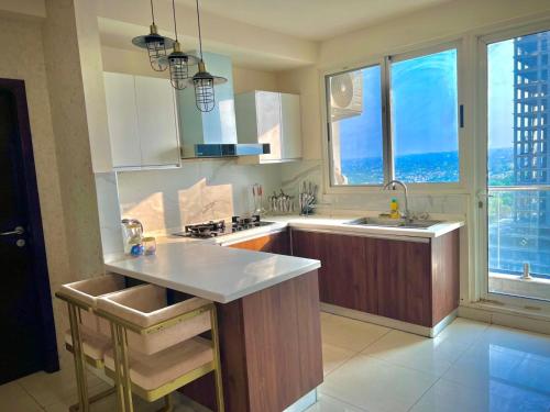 a kitchen with a sink and a counter top at Executive Apartments In The Heights of Elysium Tower - Islamabad in Islamabad