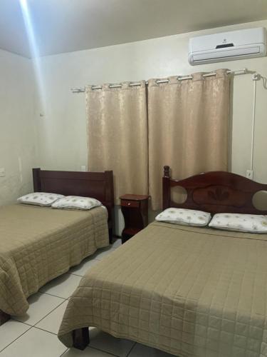 Ένα ή περισσότερα κρεβάτια σε δωμάτιο στο Casa de Praia Navegantes - 100 metros do mar