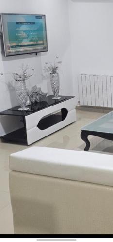 a living room with a tv on a table at Residence fedi 12 in Monastir