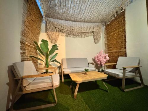 a living room with two chairs and a table at SUNRISE SEA VIEW SUITE by Eden in Paralia Katerinis