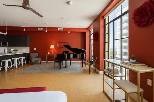 a living room with red walls and a piano in it at The Red Room - Double King Bed - Grand Piano in Dallas