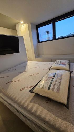 a large bed in a room with a window at Interno 8 in Padova