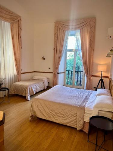 a bedroom with two beds and a window at Green Hotel in Rome