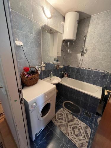a bathroom with a washing machine and a sink at Fenix Mostar in Mostar