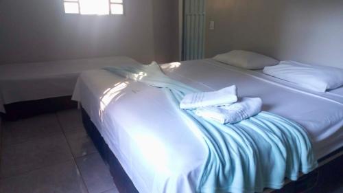 En eller flere senge i et værelse på Chácara Recanto da Paz