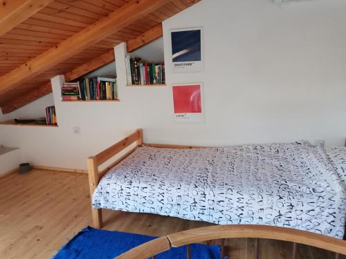 a bed in a room with a book shelf at Apartman Ustrine in Ustrine
