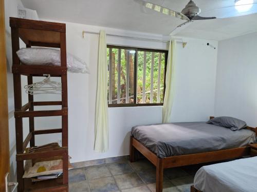 a bedroom with a bunk bed and a window at El Diamante - Playa Hermosa in Playa Hermosa
