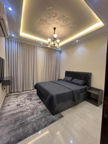 a bedroom with a bed and a ceiling at Four Stays Khobar in Al Khobar
