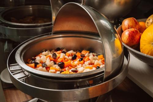 a pot full of food in a stove at Angra Beach Hotel in Angra dos Reis