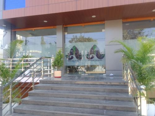 a building with stairs and plants in front of it at Mayura palace in Jaipur