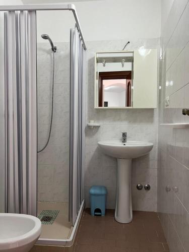 a bathroom with a sink and a shower and a toilet at Residence Nido Verde in Peschici