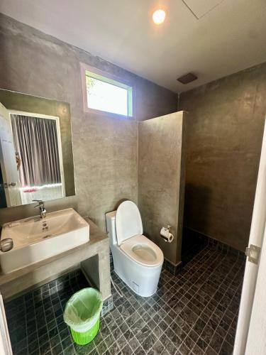 a bathroom with a toilet and a sink and a tub at Kohyao Non Bay in Ko Yao Yai
