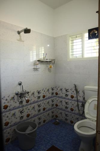 a bathroom with a toilet and a shower at Raghavendra Homestay in Kalyānpur