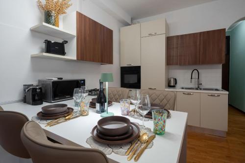 a kitchen with a table with plates and wine glasses at St Mark's Square - K Collection in Venice
