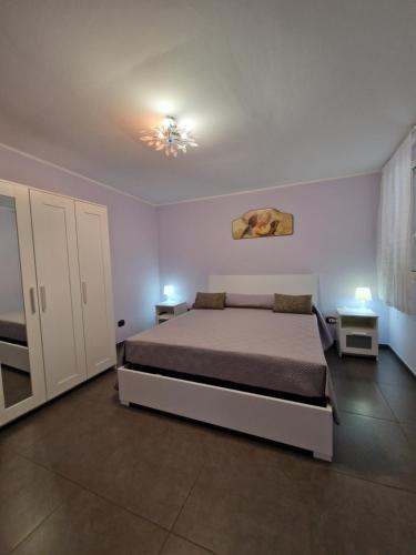 a bedroom with a bed and two tables and a chandelier at Bella Vista in Syracuse