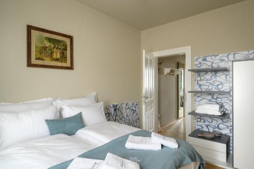 a bedroom with a bed with towels on it at Franz Apartments in Ilirska Bistrica