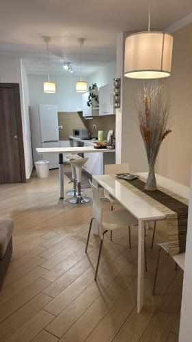 a kitchen and living room with a table and chairs at Bon Bon Il Brofferio in Asti