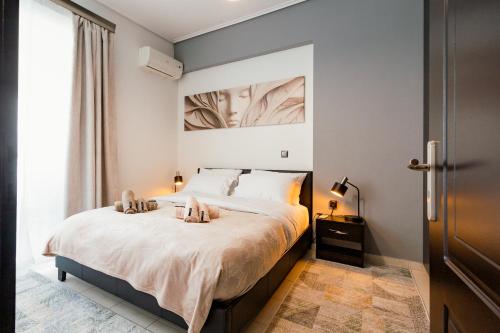 a bedroom with a bed with two shoes on it at Agnanti Apartment in Agrinio