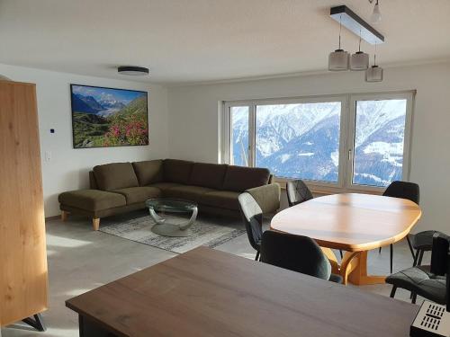 a living room with a couch and a table at Tamara Parterre in Riederalp