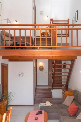 a living room with a loft bed and a couch at Lanzahost Casa Campagnolo in Playa Honda