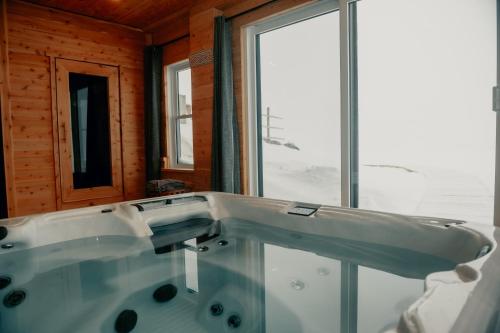 a bath tub in a room with a window at Luxury farm Stay, Alexandria in Glen Robertson