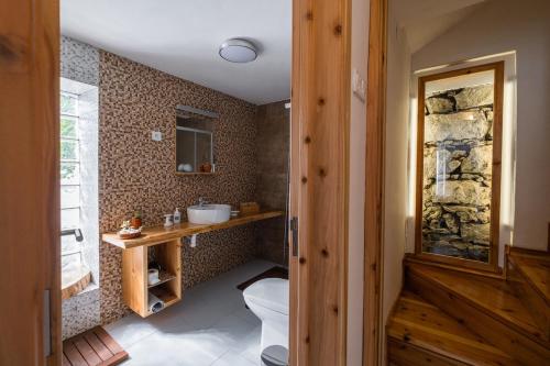 a bathroom with a toilet and a sink at Casa Sol Nascente in Ponta Delgada