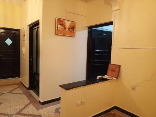 a hallway with a counter and a window and a door at Royal Stay Apartment in Benguerir