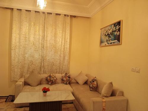 a living room with a couch and a table at Royal Stay Apartment in Benguerir
