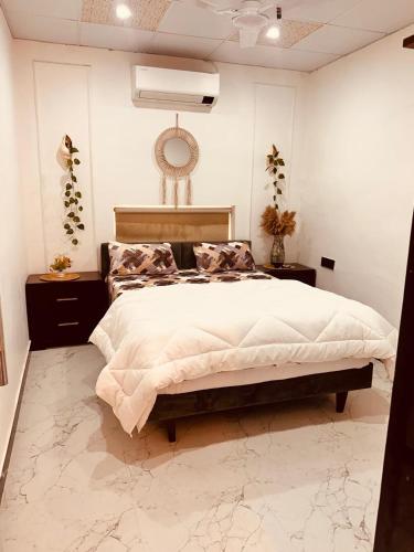 a bedroom with a large bed and a ceiling at Friends Villa Nainwal in Gurgaon