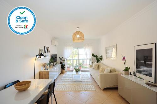 a living room with a couch and a table at B95 - Casa Melo Apartment in Praia da Luz in Luz