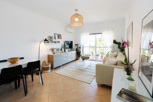 a living room with a couch and a table at B95 - Casa Melo Apartment in Praia da Luz in Luz