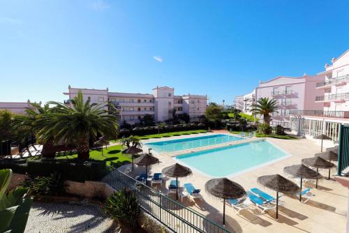a view of a swimming pool with umbrellas and chairs at B95 - Casa Melo Apartment in Praia da Luz in Luz