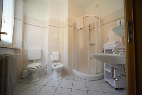 a bathroom with a toilet and a sink and a shower at Hotel Residence Sant'Anna in Bedonia