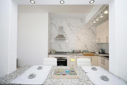 a kitchen with a table with chairs and a counter top at B50 - Main Square Apartment in Lagos in Lagos