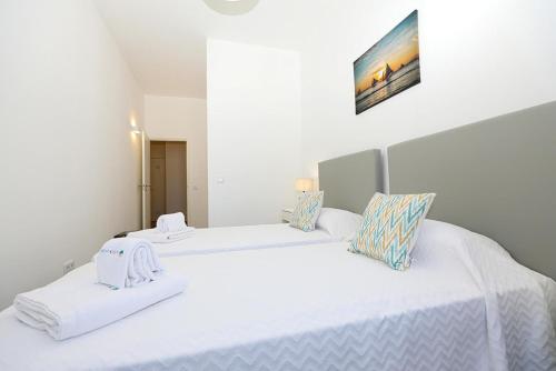 two beds in a white room with white sheets at B50 - Main Square Apartment in Lagos in Lagos