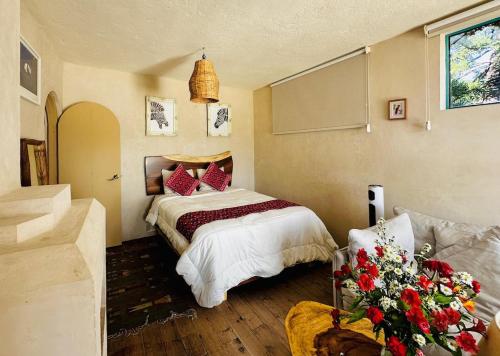 a bedroom with a bed with red pillows at Casa Laura in San Cristóbal de Las Casas
