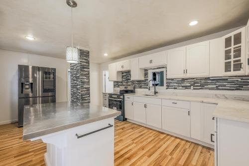 a kitchen with white cabinets and stainless steel appliances at Fairmont Suites in Worcester