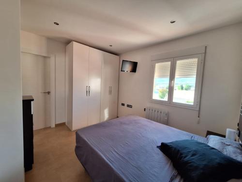 een slaapkamer met een groot bed en een kast bij Vista Noguera in Huéscar