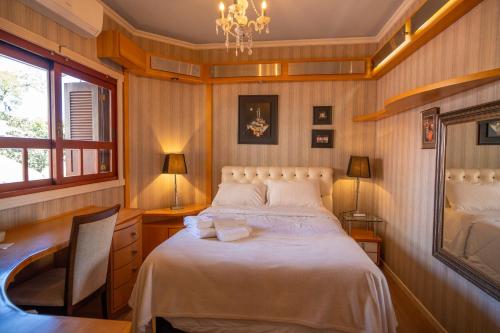 En eller flere senge i et værelse på Vivares Pousada Boutique Gramado