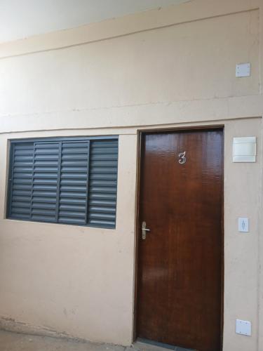two doors on the side of a building at Pousada JJFerraz in Guaratinguetá