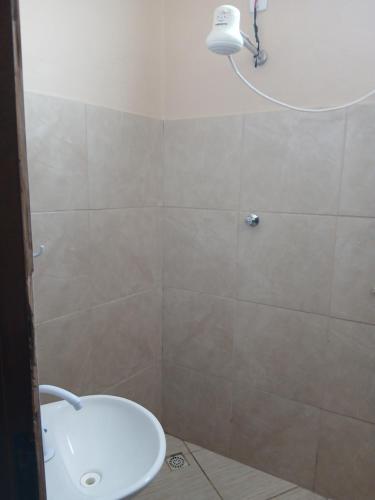 a bathroom with a shower with a toilet and a sink at Pousada JJFerraz in Guaratinguetá