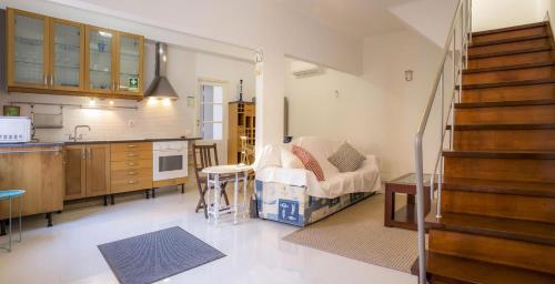 a kitchen and a living room with a couch at B34 - Central Townhouse in Lagos in Lagos