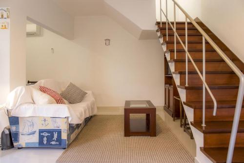 a room with a staircase with a bed and a table at B34 - Central Townhouse in Lagos in Lagos